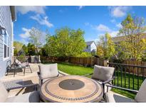 Enjoy outdoor relaxation on this backyard patio with comfortable seating and a well-maintained lawn at 16478 Marion St, Thornton, CO 80602