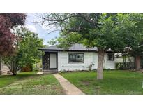 Charming single-story home with stone accents and a well-maintained lawn, situated in a quiet neighborhood at 5008 Alcott St, Denver, CO 80221