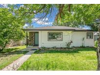 Charming single-story home with a well-maintained front yard and stone accents at 5008 Alcott St, Denver, CO 80221