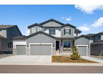 Beautiful two story home with three car garage, stone accents, and manicured lawn in a quiet neighborhood at 5861 Tesoro Pt, Parker, CO 80134