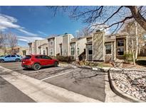 View of the exterior of a multi-unit building with assigned parking and manicured landscaping at 4634 S Fraser Ct # F, Aurora, CO 80015