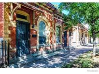Charming brick building exterior, sidewalk and mature trees creating a pleasant outdoor setting at 1767 N Washington St, Denver, CO 80203