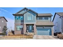 Charming two-story home featuring a blend of modern architecture and inviting curb appeal on a sunny day at 6690 Mariposa St, Denver, CO 80221