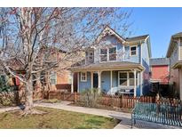 Charming two-story home with a welcoming front porch and well-maintained yard at 2533 Central Park Blvd, Denver, CO 80238