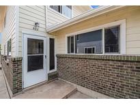 Brick building exterior with a walkway and entrance at 7309 W Hampden Ave # 402, Lakewood, CO 80227