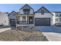 Charming two-story home with gray facade, dark trim, a 2-car garage, small porch, and contemporary xeriscaped front yard at 918 Congress Pl, Elizabeth, CO 80107