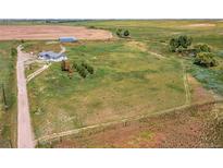 Expansive acreage featuring a modern home, barn, and private pond, offering a serene country lifestyle at 39633 E 160Th Ave, Keenesburg, CO 80643