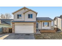 Charming two-story home features a two-car garage, manicured lawn and welcoming front porch at 13547 Quivas St, Denver, CO 80234