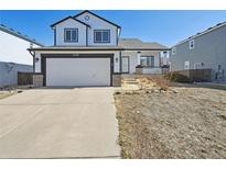 Charming two-story home with a two-car garage, inviting porch, and classic black and white trim at 8588 Sweet Clover Way, Parker, CO 80134