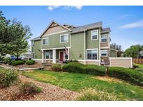 Charming two-story home with green siding and a well-manicured lawn at 15800 E 121St Ave # 4K, Brighton, CO 80603