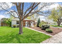 Charming single-story home with green lawn, mature trees, and a welcoming front porch at 2252 Lamar St, Edgewater, CO 80214