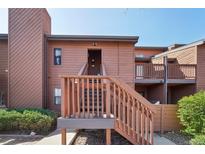 Condo exterior features wood siding, stairs to the front door, and some landscaping around the property at 540 S Forest St # 3-204, Denver, CO 80246