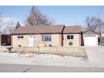 Charming brick home featuring a well-maintained lawn and a detached one car garage at 9191 Russell Way, Thornton, CO 80229