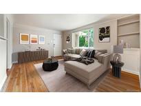 Inviting living room featuring a large sectional, wood floors, and abundant natural light at 1535 Hudson St # 1, Denver, CO 80220