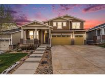 Charming two-story home featuring a three-car garage and a cozy front porch at 6173 Eldora St, Golden, CO 80403