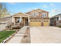 Charming two-story home boasts a three-car garage, covered porch, and well-maintained landscaping at 6173 Eldora St, Golden, CO 80403