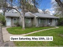 Charming single-story home with a well-maintained lawn and mature trees at 1950 Glen Shiel Dr, Lakewood, CO 80215