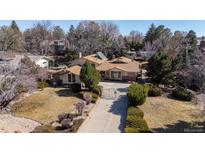 Landscaped home exterior featuring an inviting gated entrance, mature trees, and sprawling front yard at 5274 Idylwild Trl, Boulder, CO 80301