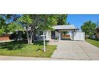 Charming home featuring a covered carport, front patio, and mature landscaping at 8610 Jolene Dr, Denver, CO 80229