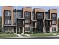 Modern townhome with a well-maintained lawn and a stylish combination of neutral and black exterior accents at 825 Josephine Way, Superior, CO 80027