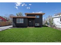 Charming home featuring a well-manicured lawn and modern, dark-colored exterior at 6641 Ash St, Commerce City, CO 80022