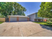 Spacious home with a three-car garage and a large driveway at 8160 W 81St Pl, Arvada, CO 80005
