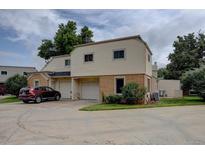 Inviting two-story home with attached garage and mature trees in front yard at 1769 S Lee St # B, Lakewood, CO 80232
