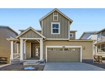 Charming two-story home showcasing a welcoming front porch and a convenient two-car garage at 5528 Inland Ave, Firestone, CO 80504