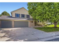 Charming two-story home boasts a well-manicured lawn, a three-car garage, and an inviting curb appeal at 2552 E 126Th Way, Thornton, CO 80241