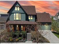 Charming two-story home with a covered porch and attached two car garage at 9437 E 51St Dr, Denver, CO 80238