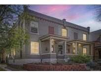Charming gray brick home with a covered front porch and beautiful brick landscaping, ideal for curb appeal at 2562 N Emerson St, Denver, CO 80205