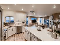 Bright, white kitchen with stainless steel appliances and large island, perfect for entertaining and everyday living at 920 W 128Th Pl, Westminster, CO 80234