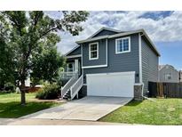 Charming two-story home features a well-manicured lawn, a two-car garage, and a front porch with lovely curb appeal at 4178 E 94Th Pl, Thornton, CO 80229