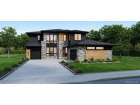 Two-story modern home with stone and wood accents, two-car garage, and landscaping at 1210 W 144Th Ct, Westminster, CO 80023