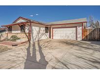 Charming home featuring a two-car garage and a well-maintained front yard with concrete driveway at 12349 E Iowa Dr, Aurora, CO 80012