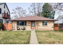 Charming brick home with walkway and well-maintained lawn, plus chairs on porch at 4571 Beach Ct, Denver, CO 80211