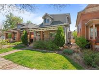 Charming two-story home featuring a stone facade, landscaped front yard, and inviting covered porch at 3354 Vallejo St, Denver, CO 80211