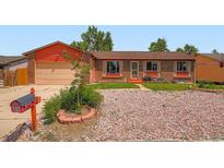 Charming brick and siding single Gathering home with well kept front yard and attached garage at 15769 E Greenwood Dr, Aurora, CO 80013