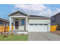 Charming single-Gathering home with a two-car garage and a welcoming front porch at 9462 Yampa Ct, Commerce City, CO 80022