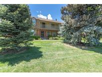 Inviting townhome with well-maintained lawn and balcony perfect for relaxing in a serene setting at 8780 E Yale Ave, Denver, CO 80231