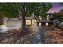 Charming home with a well-maintained lawn and mature trees creating a welcoming curb appeal at 359 S 25Th Ave, Brighton, CO 80601