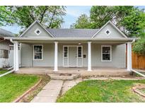 Charming single-story home featuring a covered front porch with column supports and well-maintained landscaping at 725 Knox Ct, Denver, CO 80204