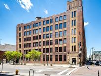 Multi-story brick building with classic architecture and an abundance of windows under a blue sky at 1863 Wazee St # 4B, Denver, CO 80202