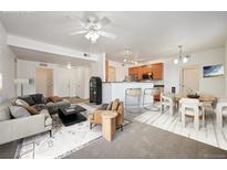 Bright living room with open floor plan, includes dining area and kitchen at 3000 Blue Sky Cir # 11-108, Erie, CO 80516
