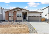 Charming single-Gathering home with brick accents, two-car garage, and a freshly landscaped front yard at 2548 Wesley Ln, Lafayette, CO 80026