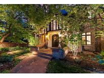 Charming brick home with a beautiful arched entryway and well-manicured landscaping at 4600 E 3Rd Ave, Denver, CO 80220