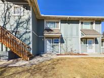 Two-story townhome featuring a private entrance and wood staircase leading to the second floor at 2269 Coronado Pkwy # C, Denver, CO 80229