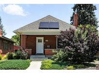 Charming brick home with solar panels, well-maintained landscaping, and a welcoming front entrance at 2660 Julian St, Denver, CO 80211