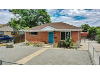 Brick ranch home with landscaped yard and walkway at 7020 Avrum Dr, Denver, CO 80221