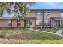 Inviting townhouse featuring a well-maintained lawn and charming exterior details at 3706 S Fairplay Way, Aurora, CO 80014